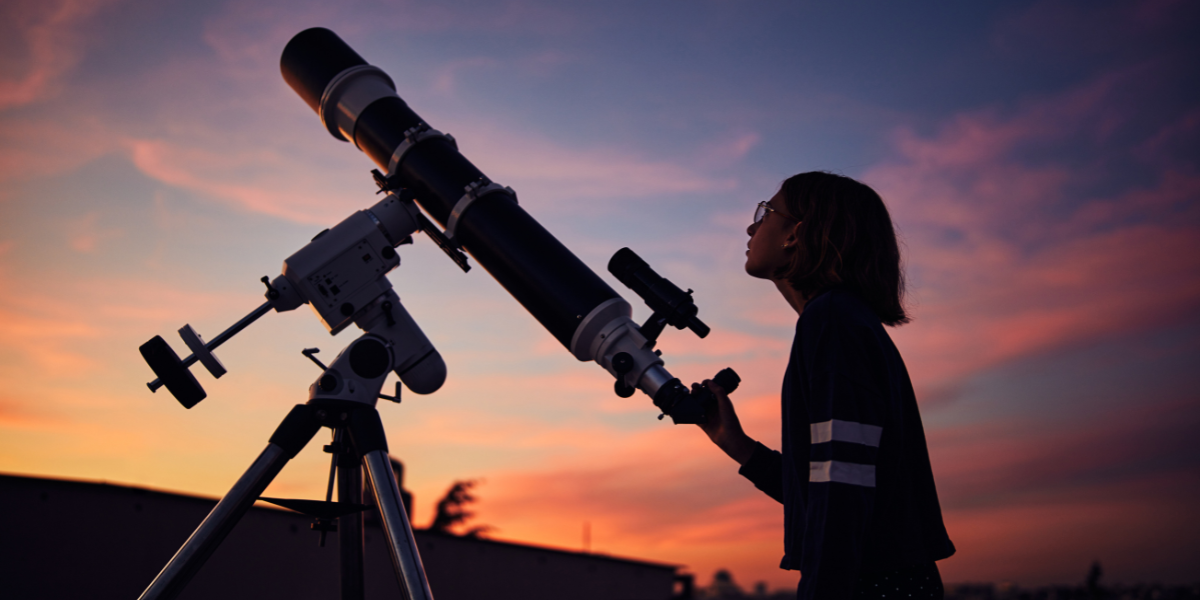 Young person getting excited about space while using a telescope during sunset, exploring the night sky as part of hands-on astronomy learning for kids.