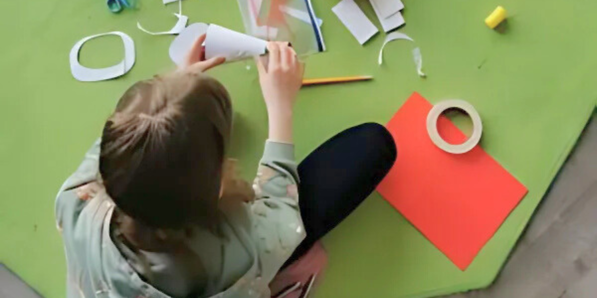 Image showing parent and child engaged in hands-on educational crafting project. Perfect example of fun and educational science activities for kids and moms to enjoy together while developing problem-solving skills.