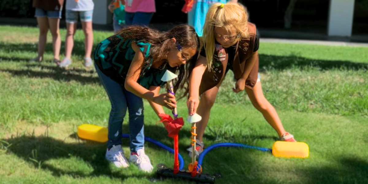 Children participating in a hands-on rocket launch experiment during an Engineering For Kids<sup srcset=